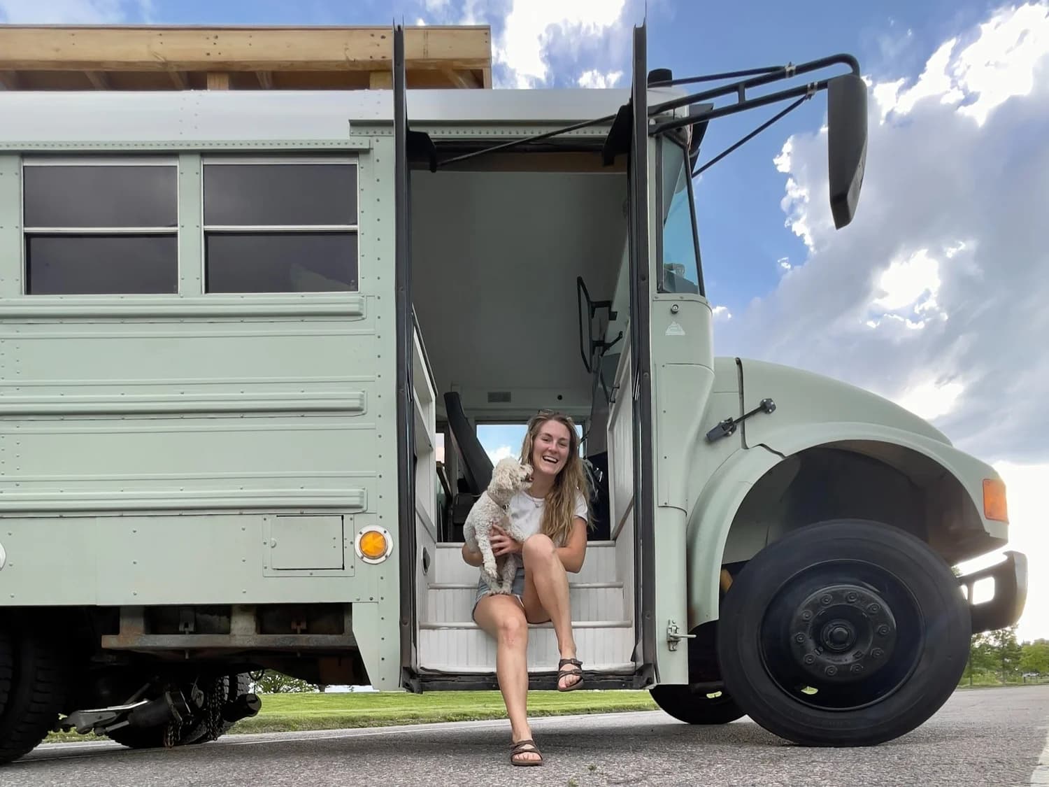 Paige and her dog Dumpling in a converted school bus